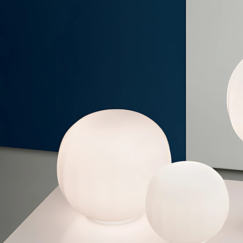 The large 12 inch Lita Table Lamp from Luceplan in white aluminum in a family area.