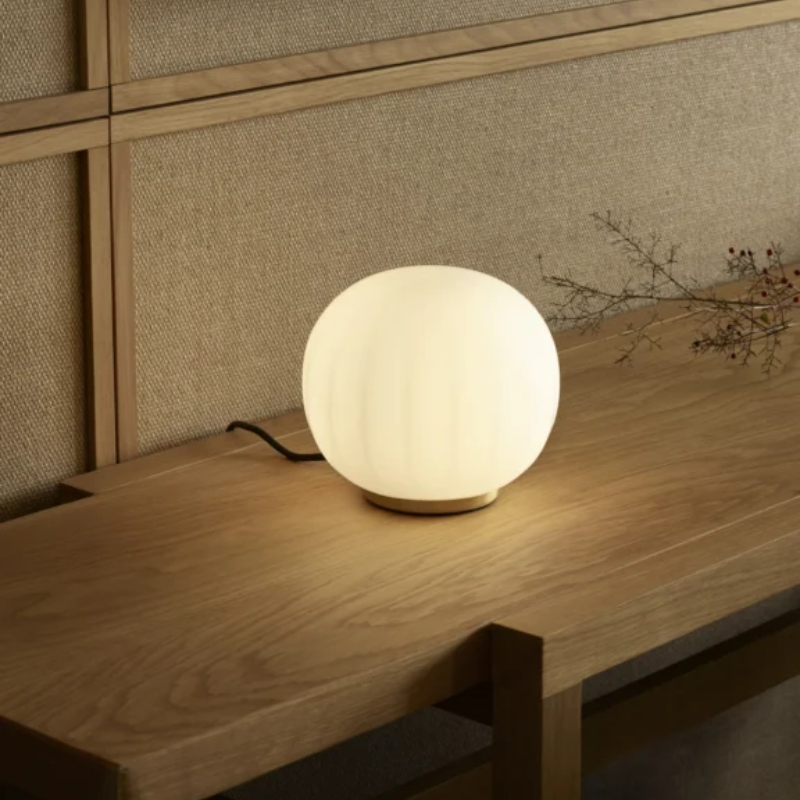The small 7 inch Lita Table Lamp from Luceplan in a living room.