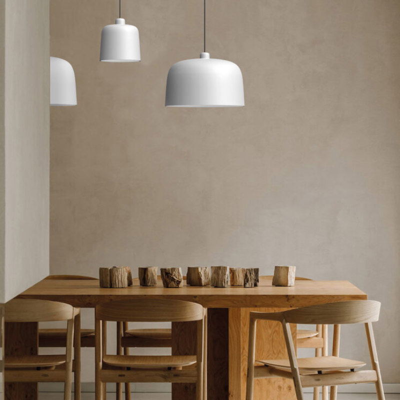 The Zile Pendant from Luceplan in matte white in a dining room.