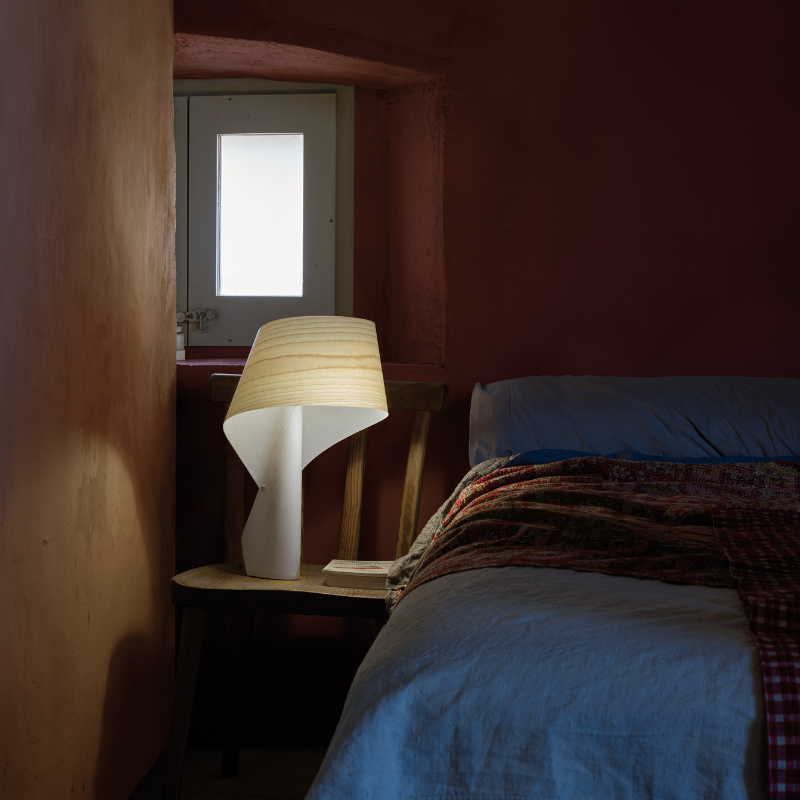 The Air Table from LZF lamps in ivory white in a primary bedroom.