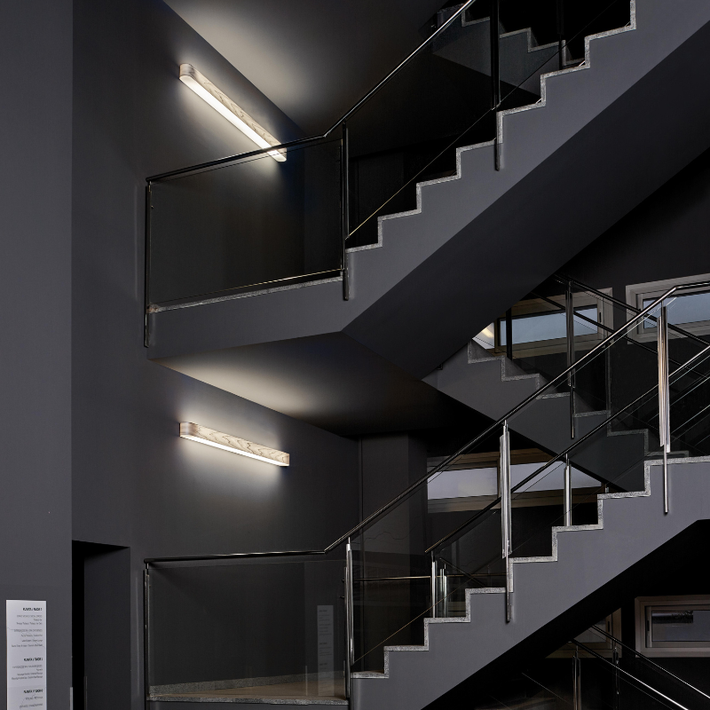 The I-Club Small Wall from LZF lamps with grey veneer in a business office stairwell.