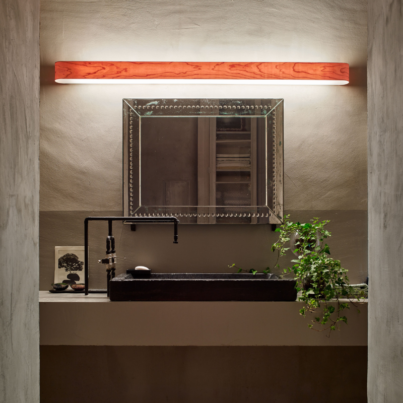 The I-Club Small Wall from LZF lamps with natural cherry veneer in a bathroom.