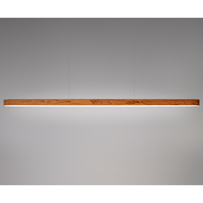 The Long I-Line Suspension from LZF lamps with the natural cherry veneer in a studio.