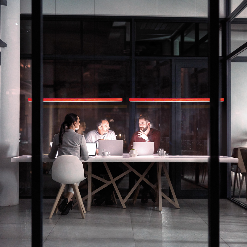 The Long I-Line Suspension from LZF lamps with the red veneer in a business space.