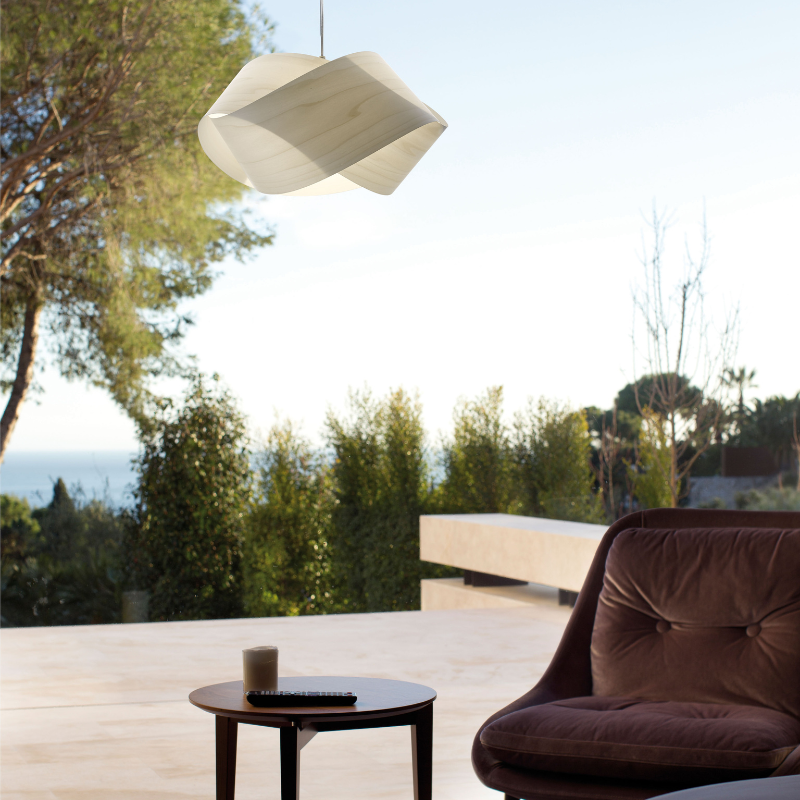 The Nut Suspension from LZF Lamps in ivory white in a family room.