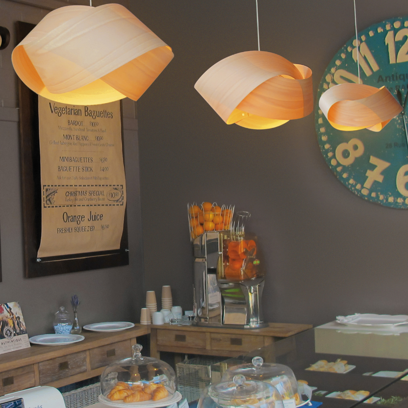The Nut Suspension from LZF Lamps in natural beech in a bakery business.