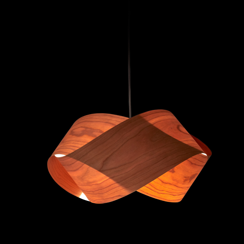 The Nut Suspension from LZF Lamps in natural cherry in a studio.