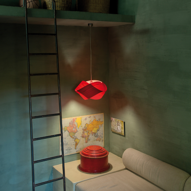 The Nut Suspension from LZF Lamps in red in a living room.