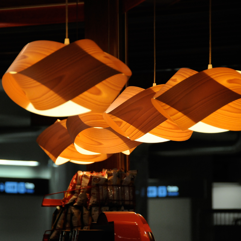 The Nut Suspension from LZF Lamps in yellow in a commercial space.