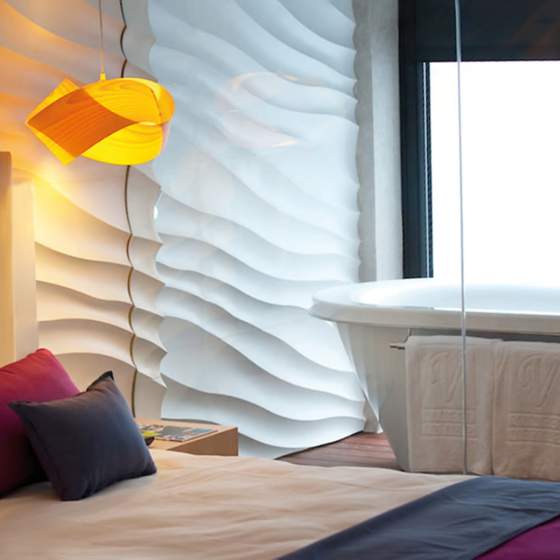 The Nut Suspension from LZF Lamps in yellow in a guest bedroom.