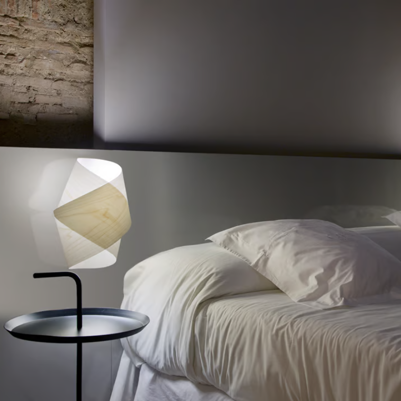 The Orbit Wall from LZF lamps in ivory white used as a bedside light.
