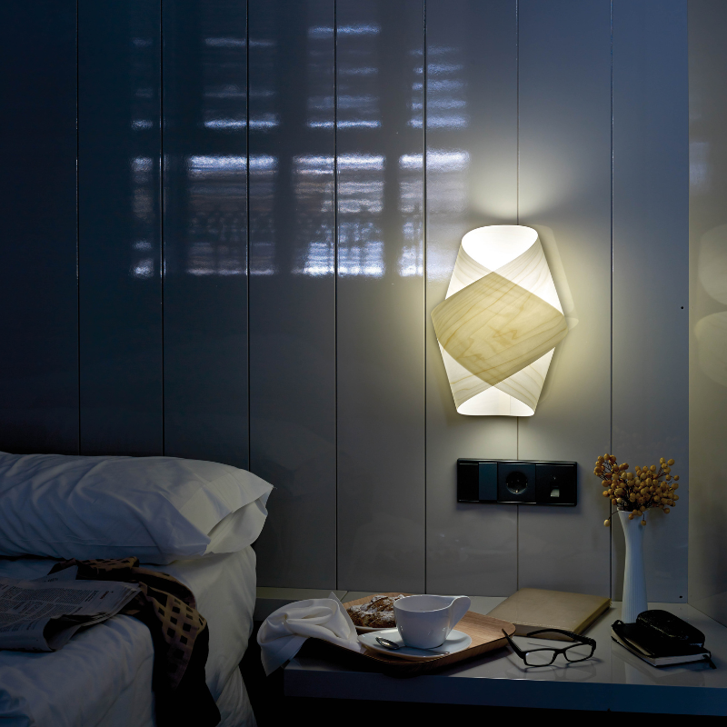 The Orbit Wall from LZF lamps in ivory white in a guest bedroom.