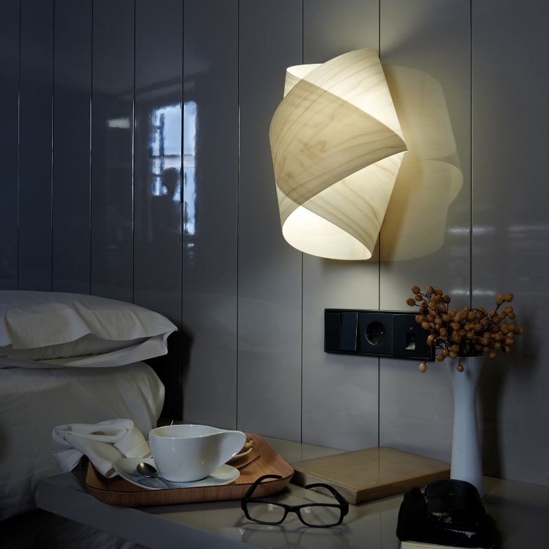 The Orbit Wall from LZF lamps in ivory white in a hotel room.