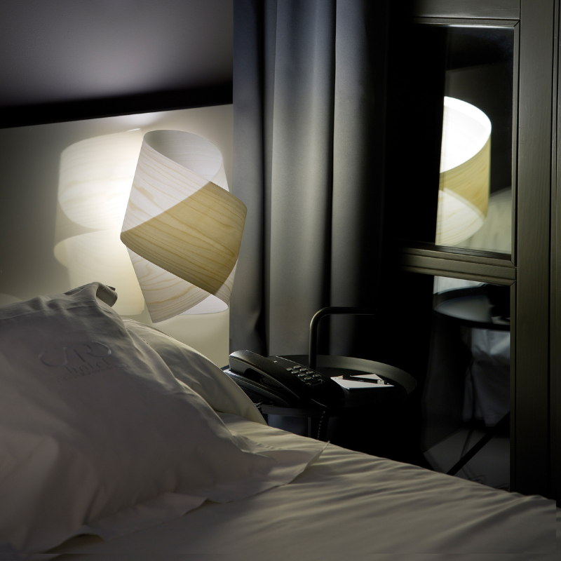 The Orbit Wall from LZF lamps in ivory white in a primary bedroom.