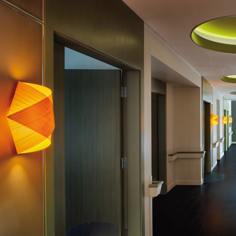 The Orbit Wall from LZF lamps in yellow in a commercial space.