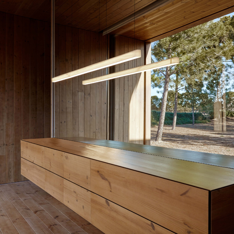 The Short I-Line Suspension from LZF lamps with ivory white veneer in a family room.