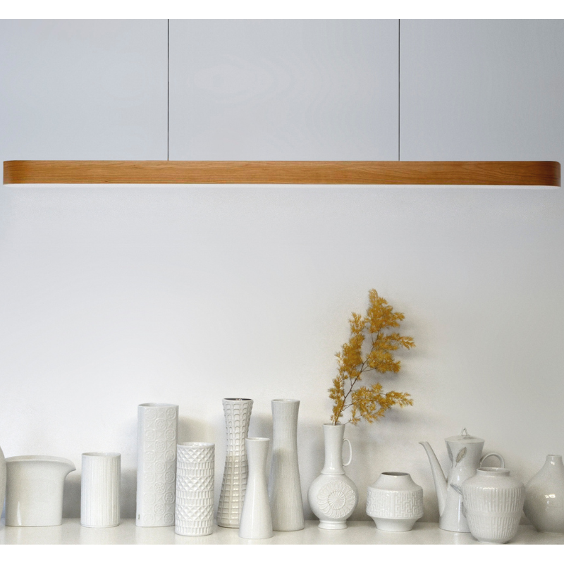 The Short I-Line Suspension from LZF lamps with natural cherry veneer in a kitchen and dining setting.