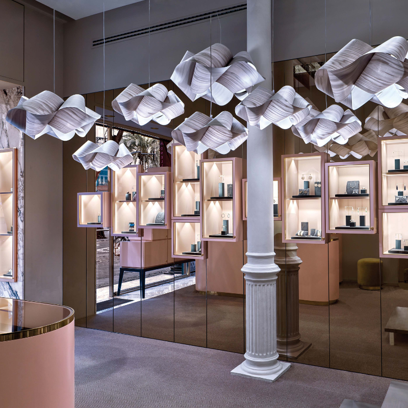 The Swirl Suspension from LZF Lamps in grey in a store front.