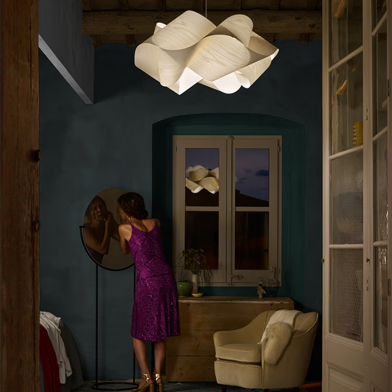 The Swirl Suspension from LZF Lamps in ivory white in a bedroom.