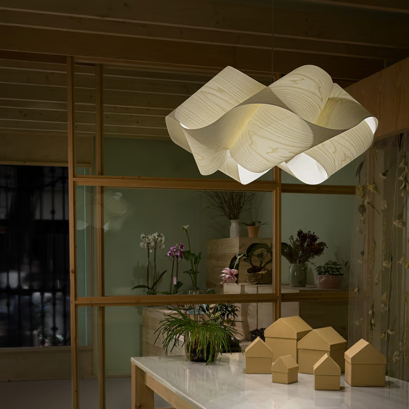The Swirl Suspension from LZF Lamps in ivory white in a living room.