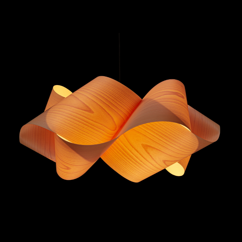 The Swirl Suspension from LZF Lamps in natural beech in a studio.