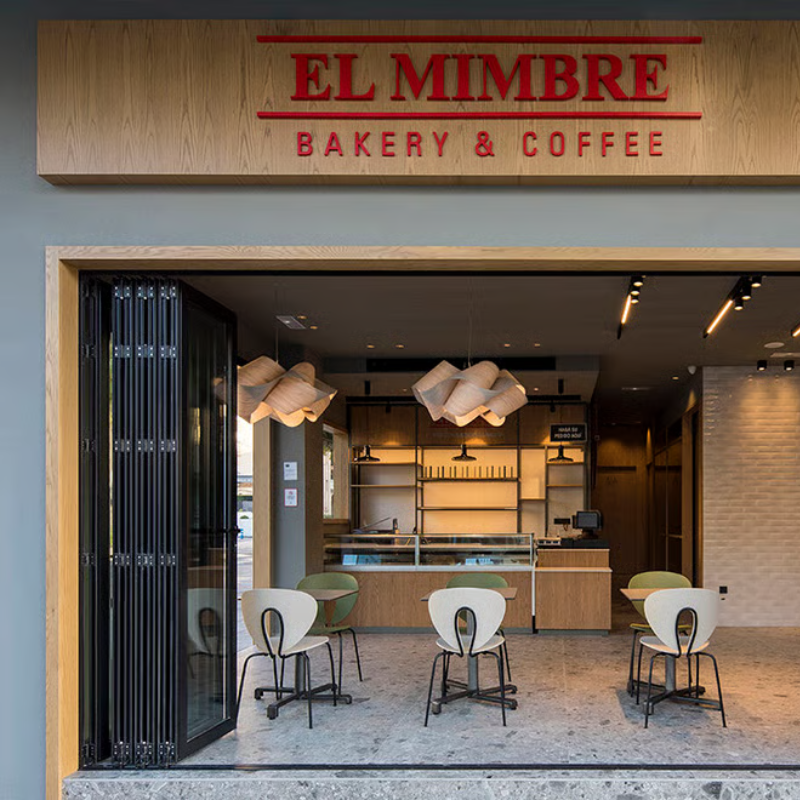 The Swirl Suspension from LZF Lamps in pale rose in a coffee shop.