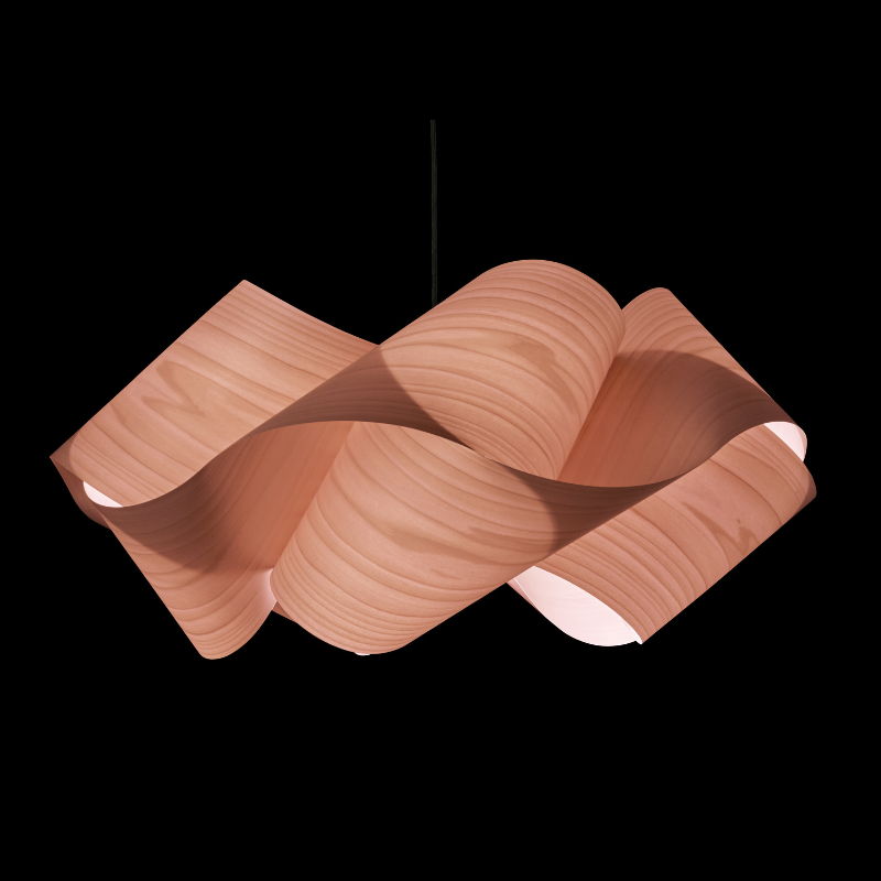 The Swirl Suspension from LZF Lamps in pale rose in a studio.