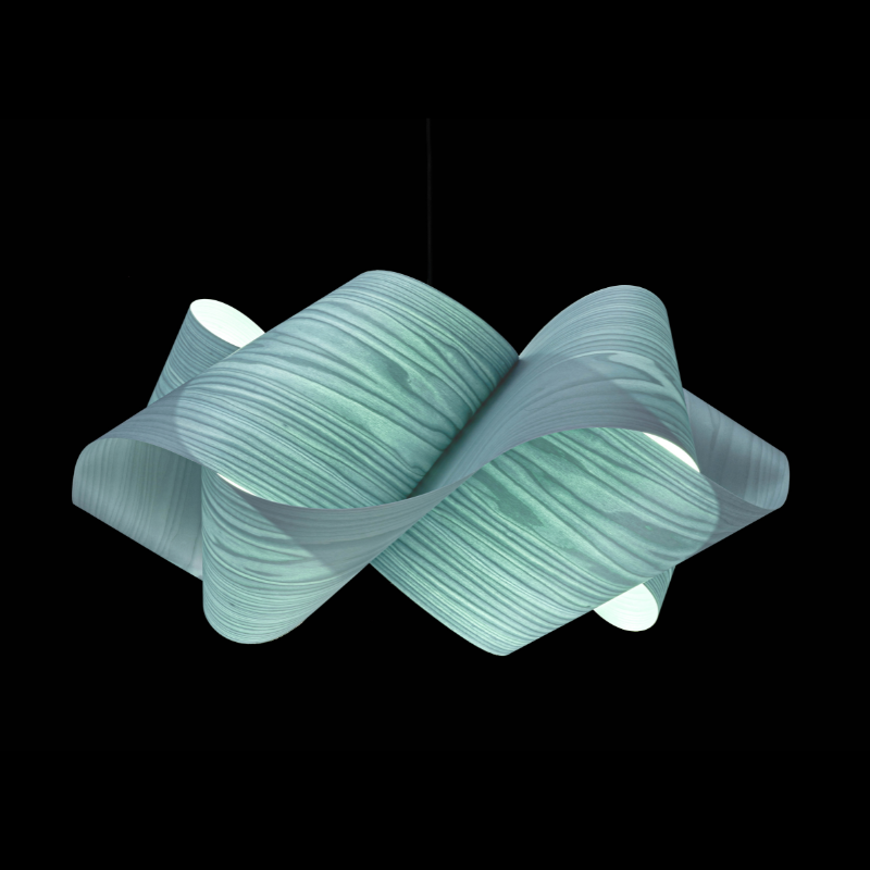 The Swirl Suspension from LZF Lamps in sea blue in a studio.