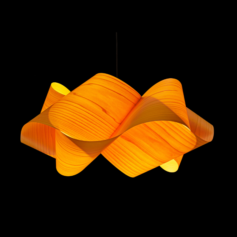 The Swirl Suspension from LZF Lamps in yellow in a studio.