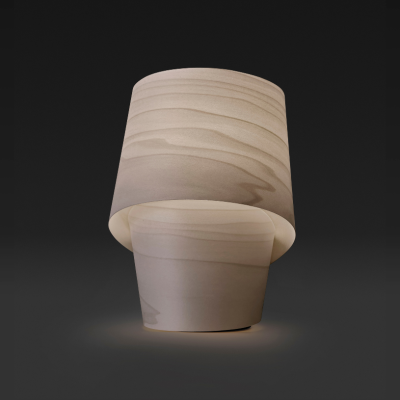 The Tiny Table from LZF lamps in grey in a studio.