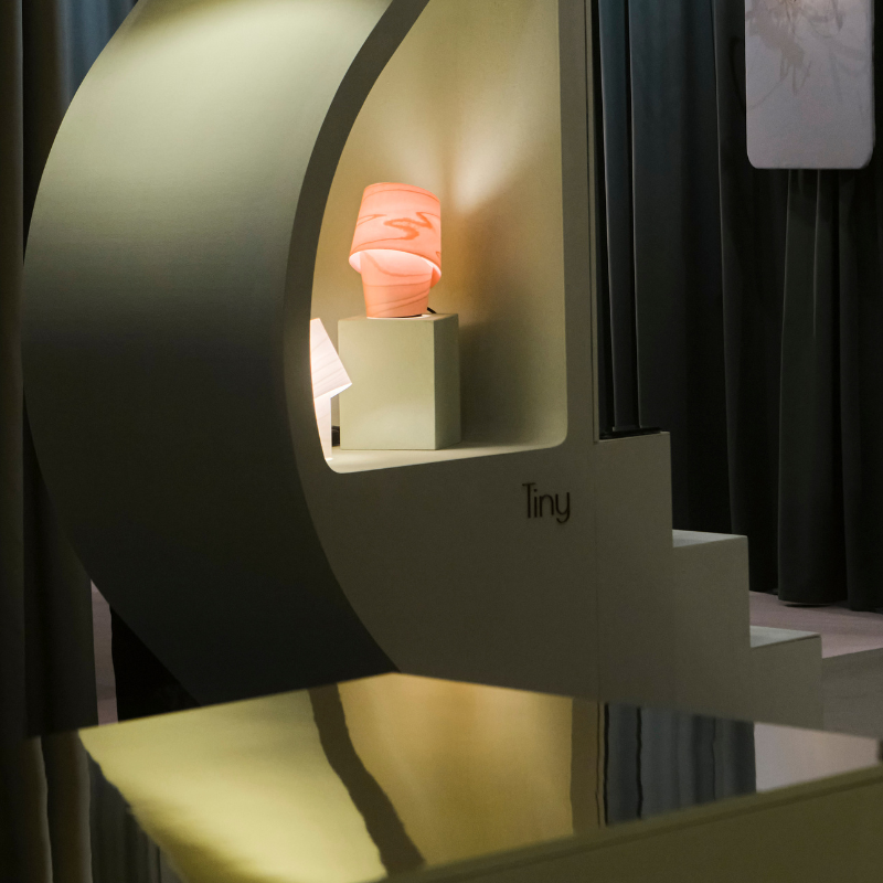 The Tiny Table from LZF lamps in ivory white in a showroom.