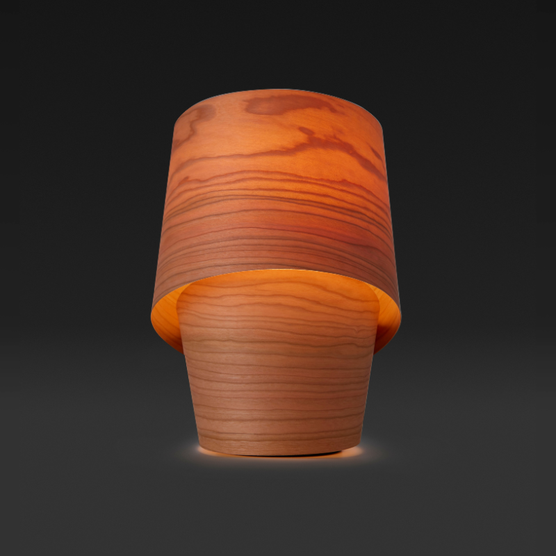 The Tiny Table from LZF lamps in natural cherry in a dark room.
