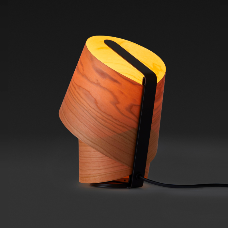 The Tiny Table from LZF lamps in natural cherry turned on in a studio.