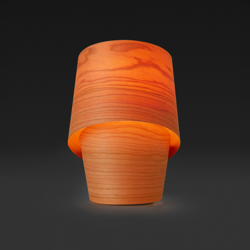 The Tiny Table from LZF lamps in orange in a studio.