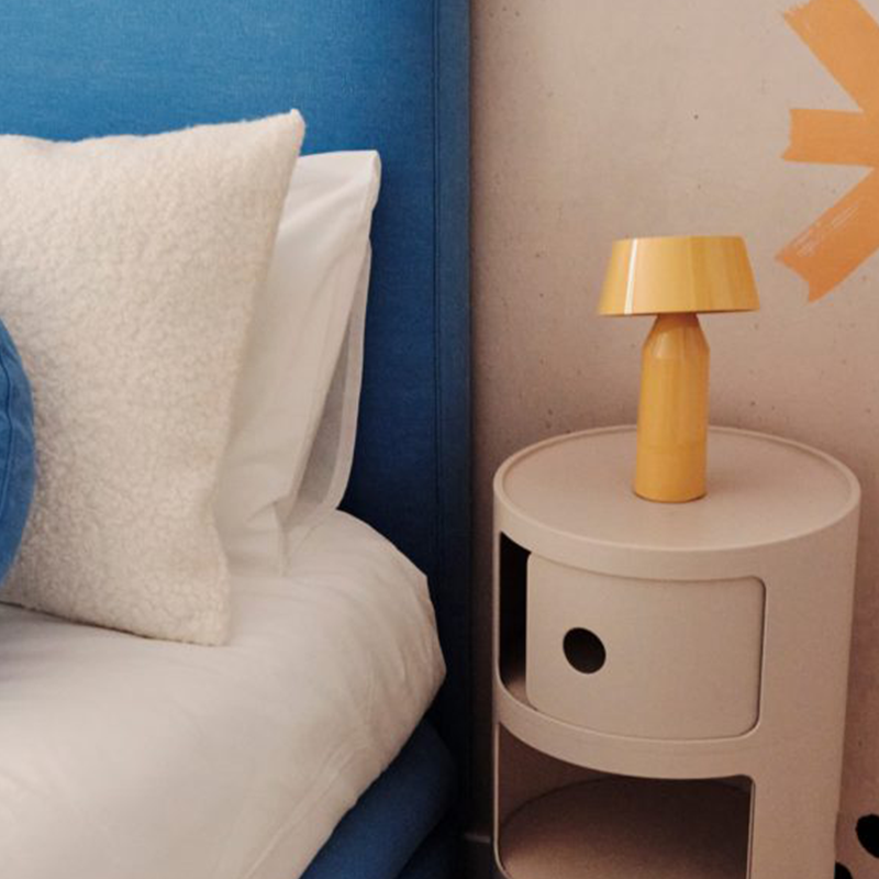 The Bicoca Portable Table Lamp from Marset in yellow in a family space.