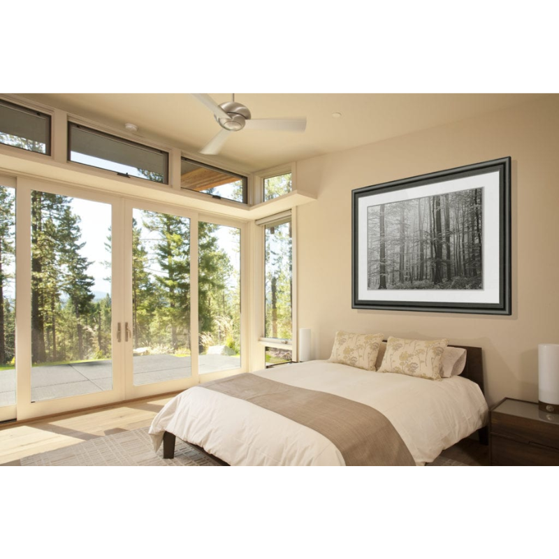 The Altus suspended ceiling fan from The Modern Fan Co. in a bedroom.