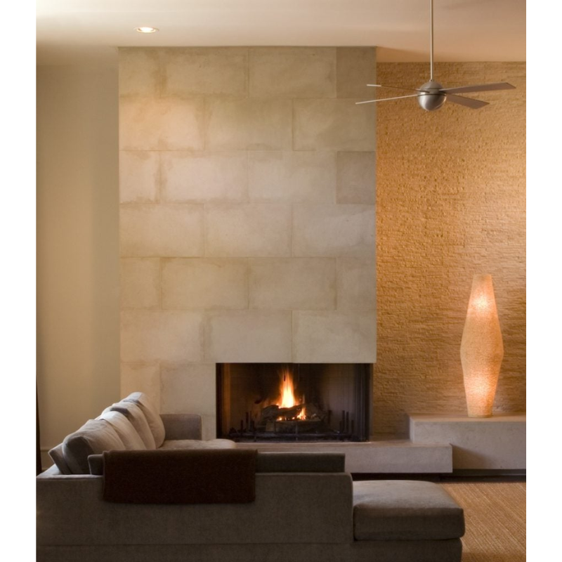 The Ball ceiling fan from The Modern Fan Co. in a living room with a fireplace.