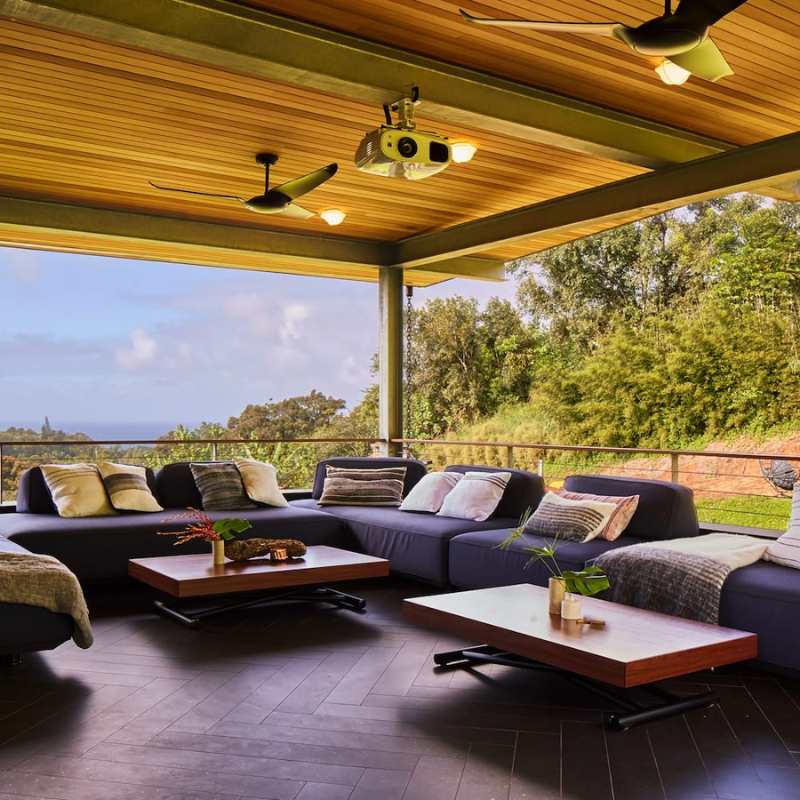 Two of the IC/Air3 DC - 56″ from the Modern Fan Co. in an outdoor lounge area.