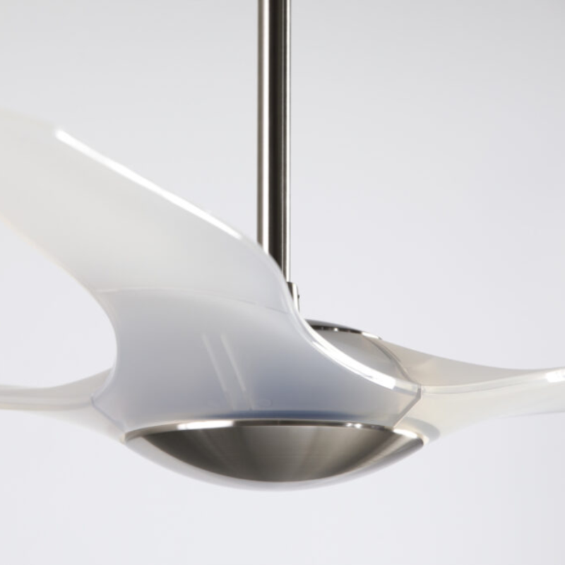 The bright nickel and translucent IC/Brisa DC - 56″ from Modern Fan Co. in a close up within a studio.