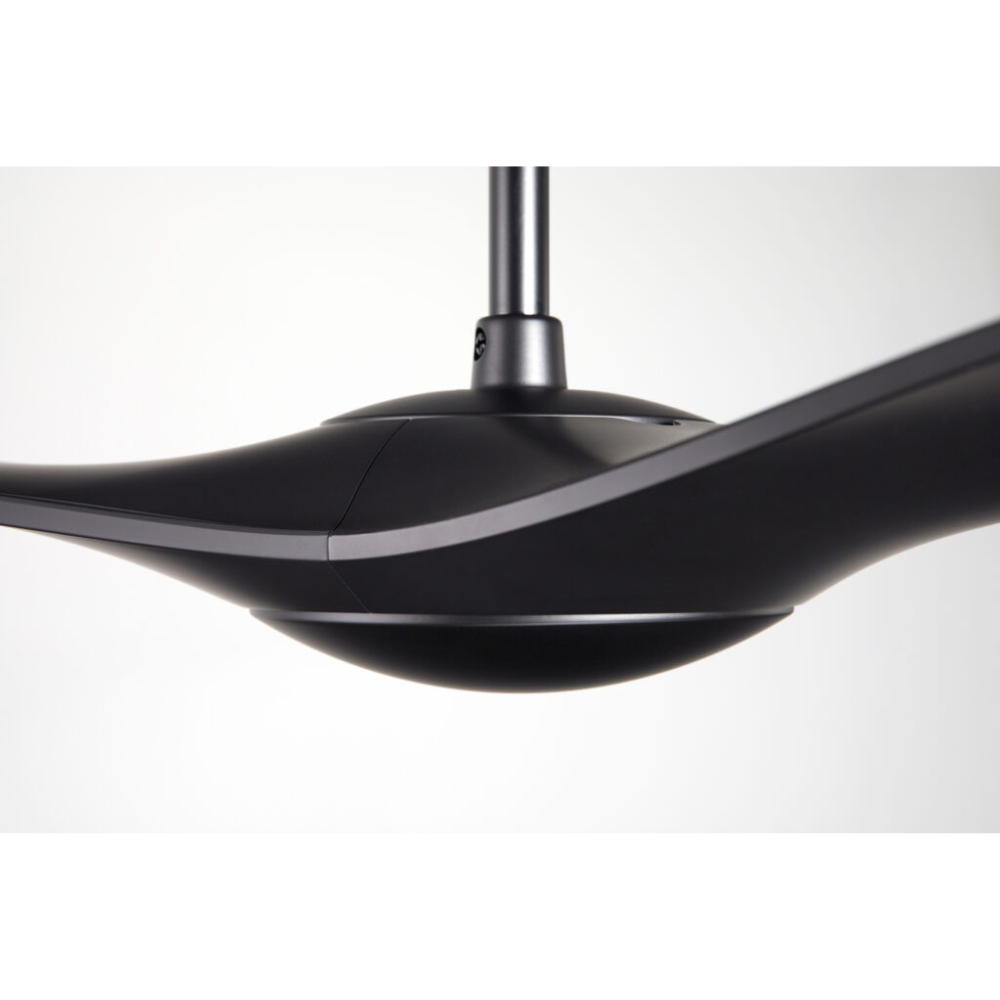 The matte black IC/Brisa DC - 56″ from Modern Fan Co. in a view from the side within a studio.