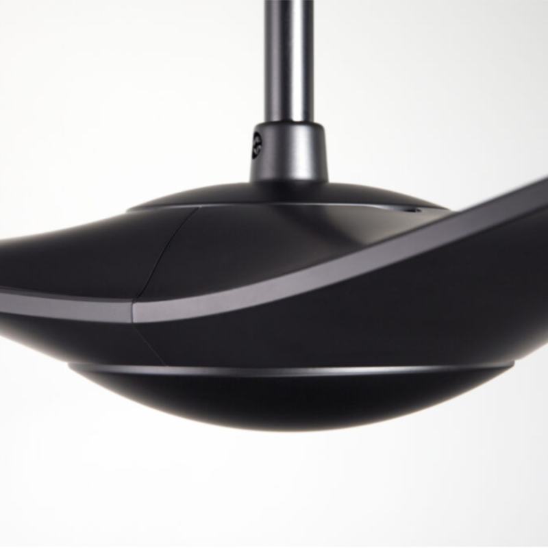 The matte black IC/Brisa DC - 56″ from Modern Fan Co. in a view from the side within a studio.