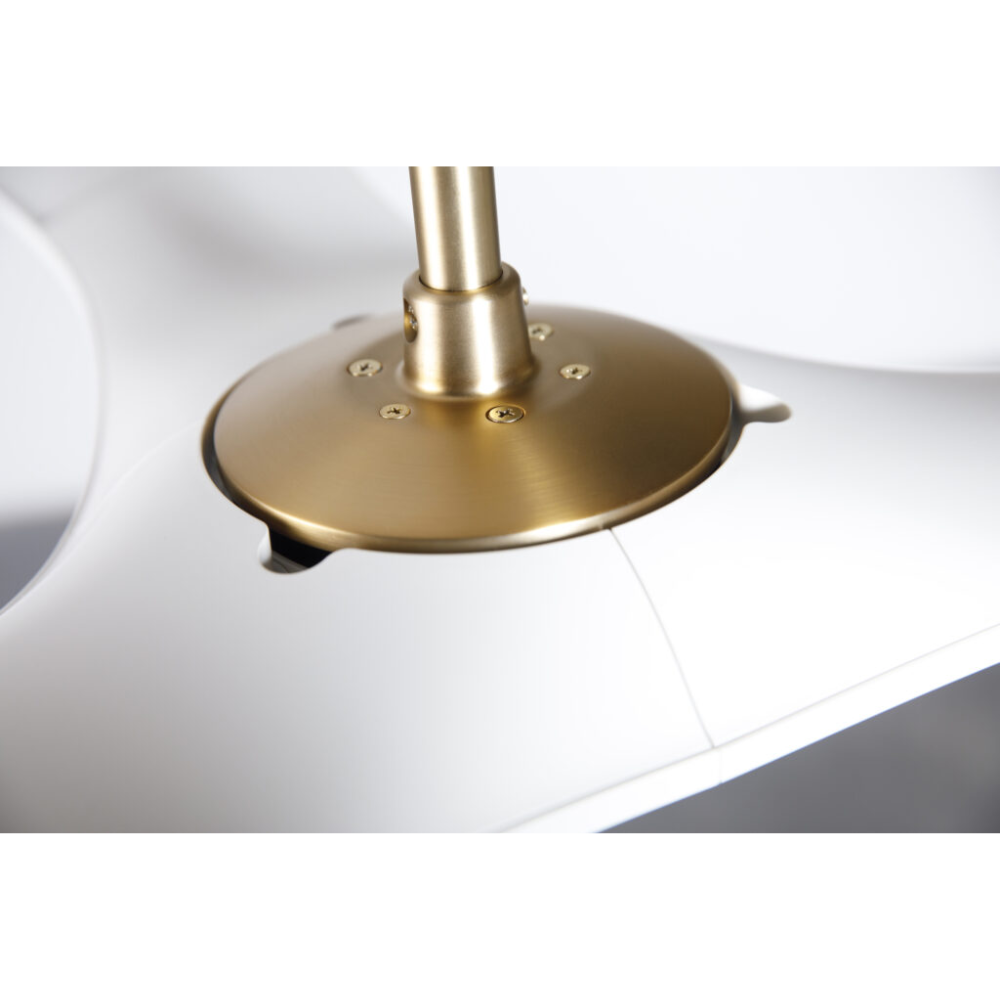 The satin brass and matte white IC/Brisa DC - 56″ from Modern Fan Co. shown close up within a living room.