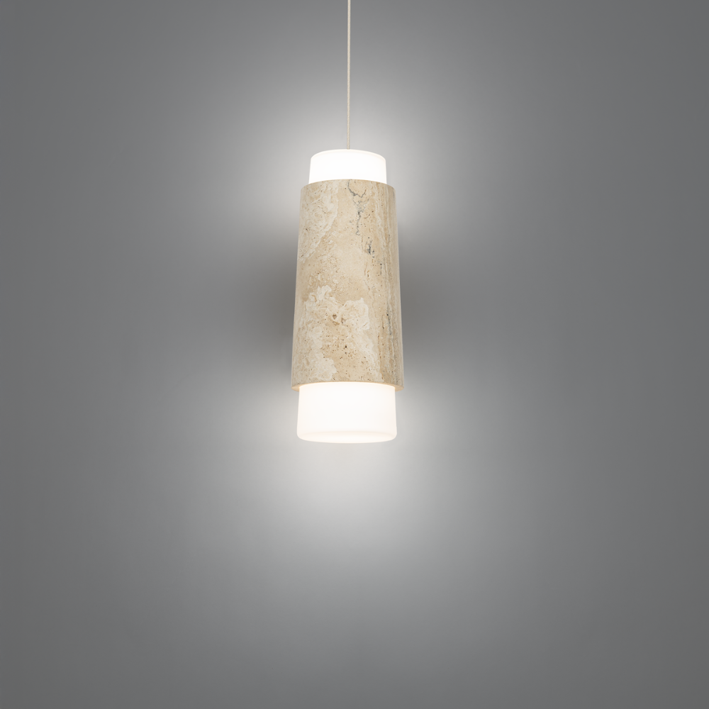 The beige travertine and aged brass Chauncey Pendant Light from Modern Forms in a studio.
