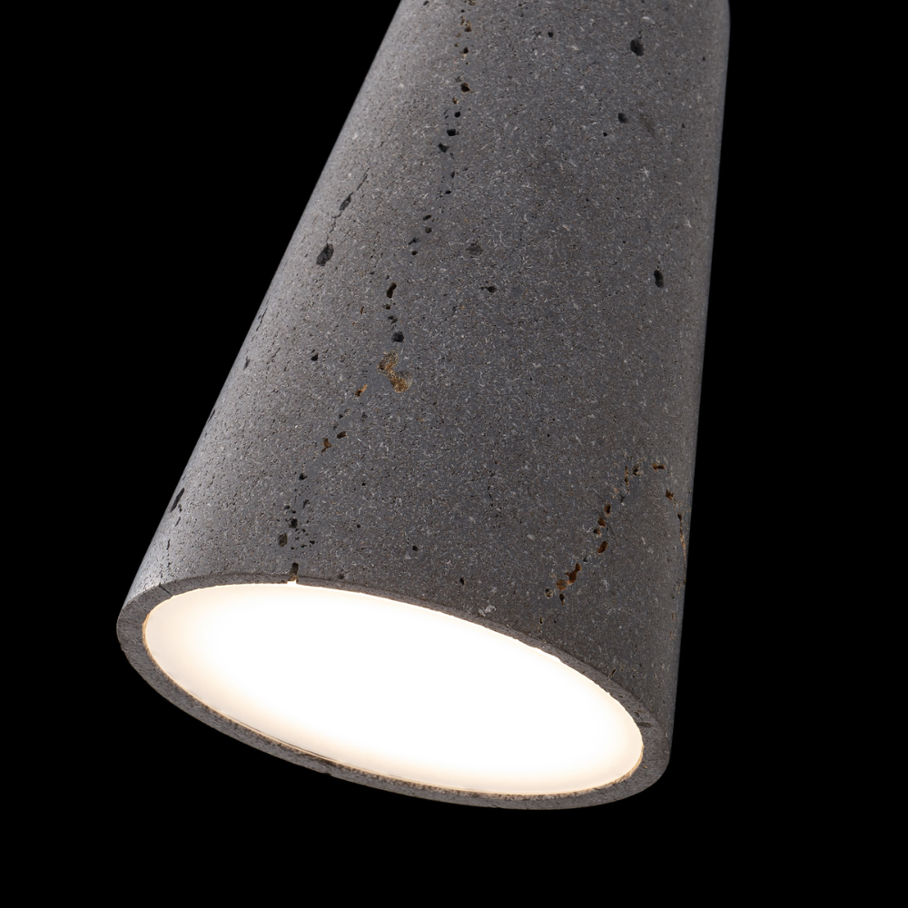 The basalt stone and black Pompeii Pendant Light from Modern Forms in a bedroom.