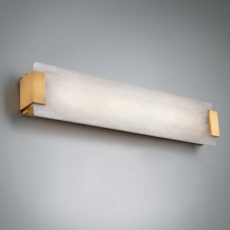 The aged brass Quarry from Modern Forms in a bathroom used as a vanity light.