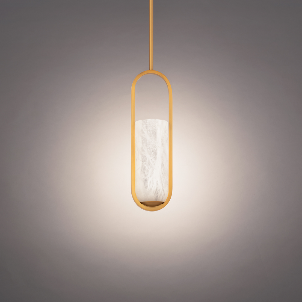 The aged brass Rollins Pendant Light from Modern Forms in a studio.