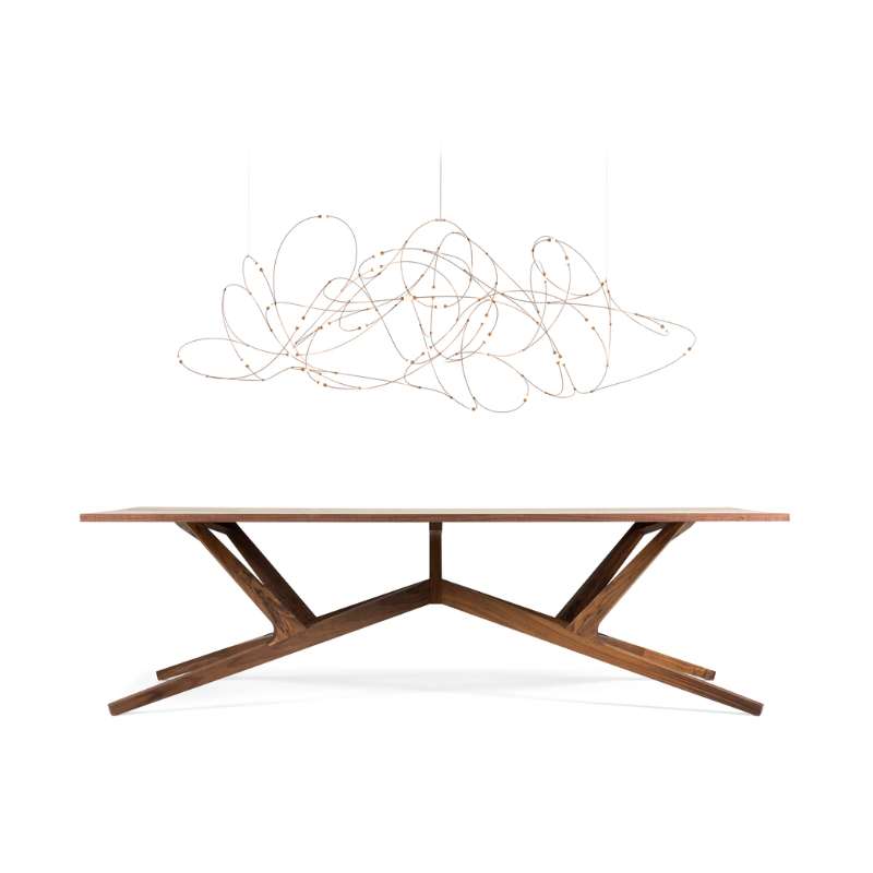 The large thirty one light Flock of Light from Moooi above a dining table in a studio.