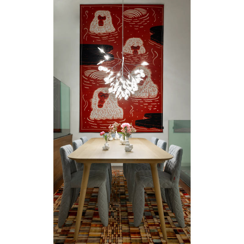 The white Heracleum III Linear from Moooi in a dining room.