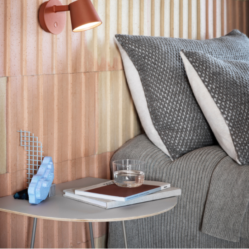 The Airy Coffee Table from Muuto in gray in a primary bedroom.