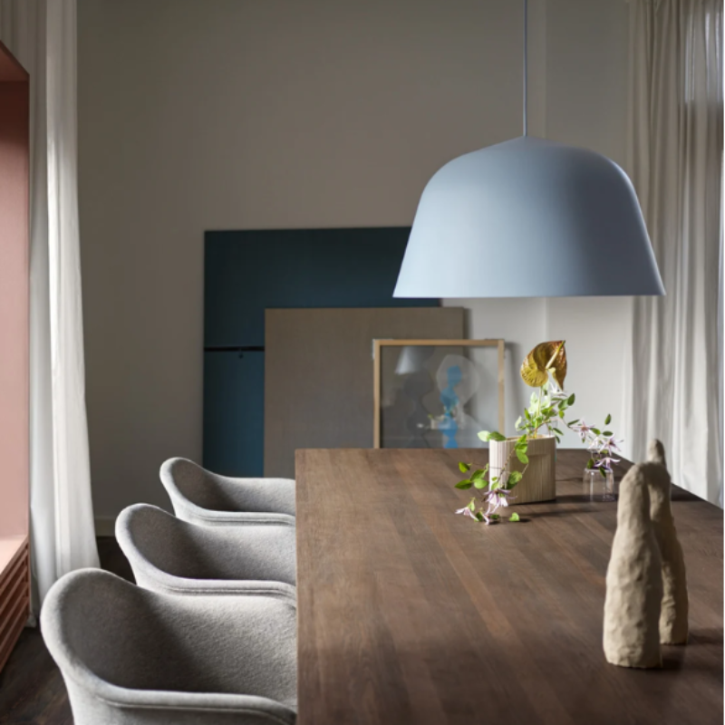 The light blue Ambit Pendant Lamp from Muuto in a dining room.